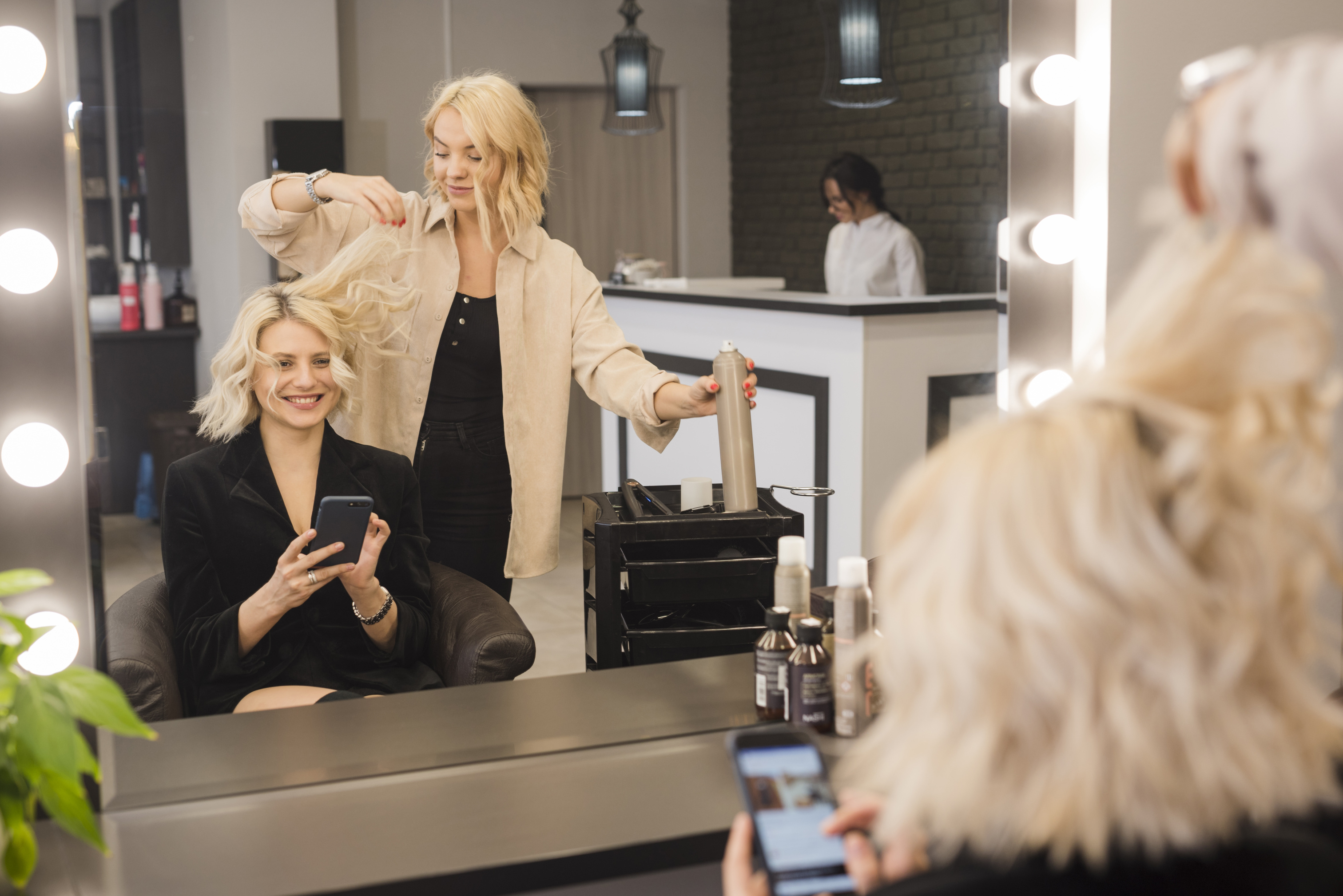 blonde-woman-with-mobile-phone-getting-her-hair-done.jpg